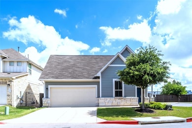 View of front of property with stone siding, a ga
