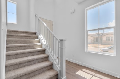 Stairway with baseboards and wood finished floors