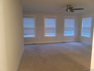 Spare room with light carpet and ceiling fan