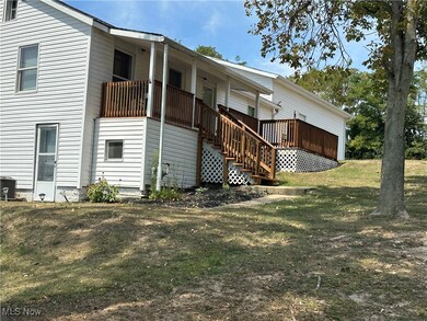 Back of property featuring a lawn