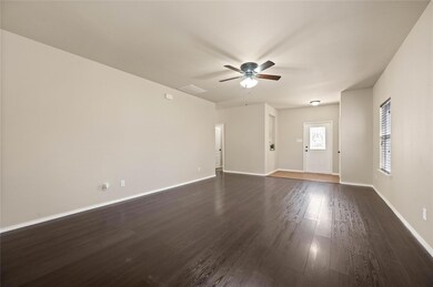 Unfurnished living room featuring dark wood finish