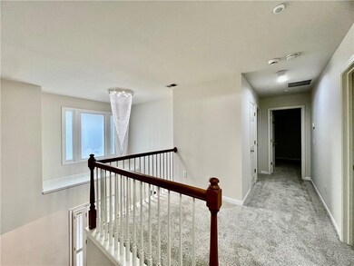Hall featuring an upstairs landing and carpet floors