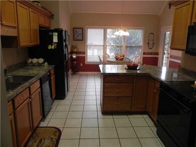 Another view of this spacious kitchen with rich pa