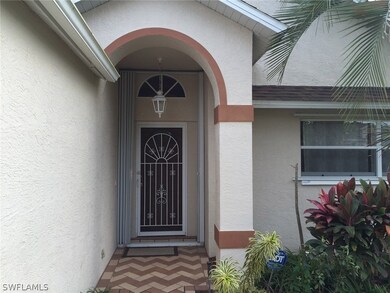 Front entry, screened door, accordion shutters.