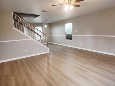 Unfurnished living room featuring a ceiling fan, 