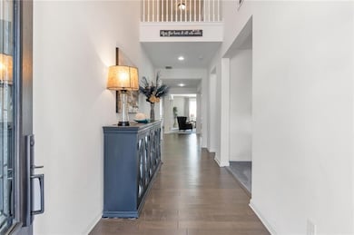 Hall with baseboards and dark wood-type flooring
