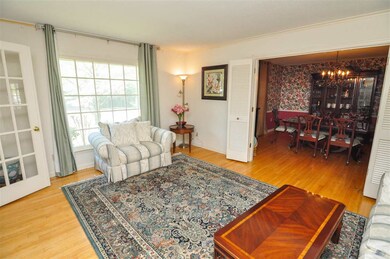 The living room also features smooth ceilings, lar