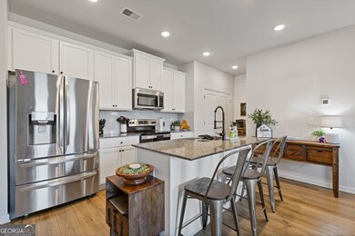 Open kitchen with an eat-in kitchen island is perfect for quick family meals or entertaining.