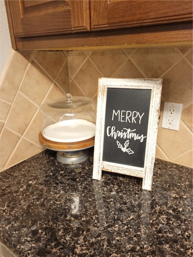 Room details featuring brown cabinets and dark sto