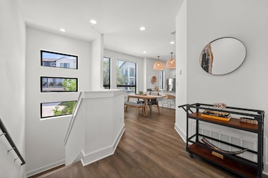 Hall featuring dark wood-style flooring, baseboar