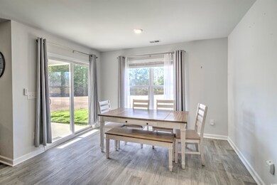 Dining area featuring visible vents, baseboards, and wood finished floors