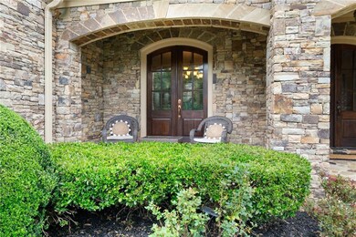 Entrance to property with stone siding and french doors