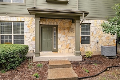 View of exterior entry featuring stone siding