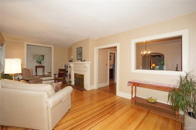 Living room with decorative mantel built-in shelvi