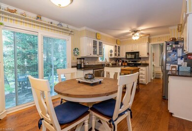 Large eat-in kitchen with breakfast area overlooking the patio and lush back yard