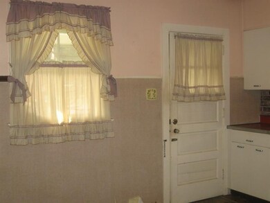 Kitchen door leading to covered back porch.