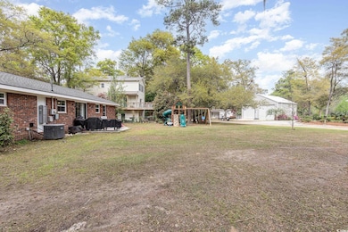 View of yard featuring central AC unit and a playg