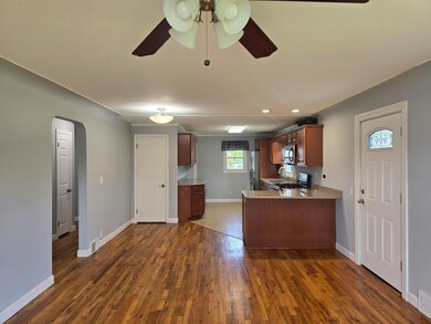 This provides a look of the living room towards the kitchen