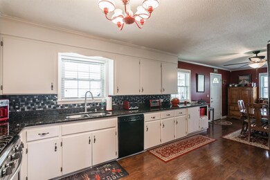 No shortage of cabinet space and new granite countertops along with back splash add elegance here.