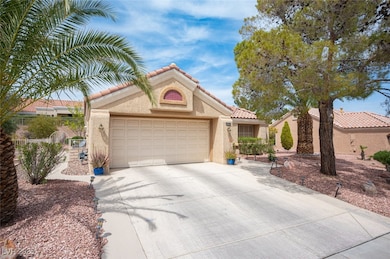 Mediterranean / spanish-style house with stucco siding, driveway, a tile roof, a garage, and fence