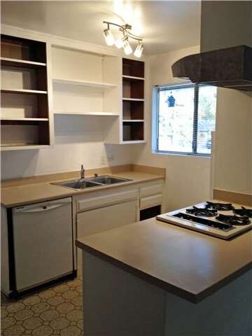 Open kitchen with cooktop + breakfast bar has lots