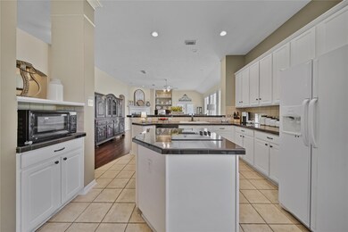 Another view of the kitchen with a breakfast bar that is open to the living room.