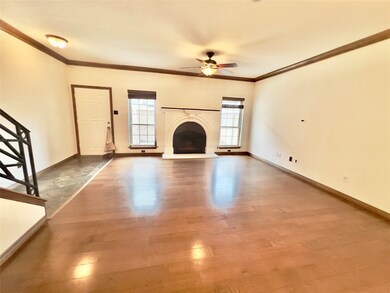 This is a spacious, well-lit room with hardwood fl