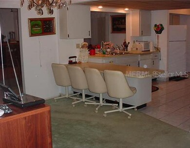 Kitchen - Kitchen has ceramic tile flooring, large breakfast bar, and pass thru to the family room. Nice light neutral colors through out.