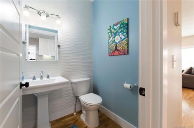 Main Level Modern Powder Room with Tile Wall
