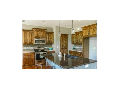 Open kitchen w/ large granite island & huge walk i