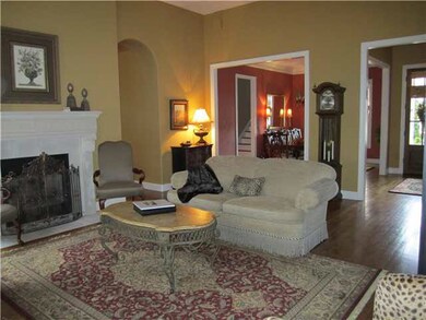 Seperate living room has tall ceilings, gleeming h