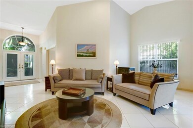 Living area featuring high vaulted ceiling, tile floors, lots of natural light