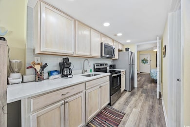 Kitchen with backsplash, a sink, appliances with s