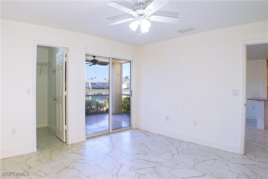 Spare room with a water view and ceiling fan