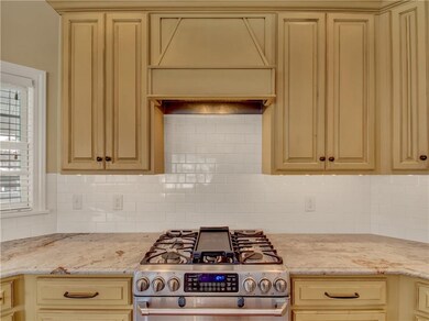 Designer kitchen features granite counter tops and