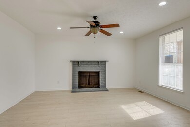 The living room boasts warm flooring, lovely fireplace and great windows