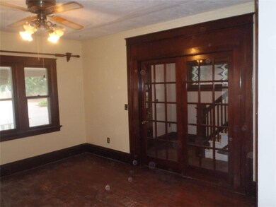 Two French doors separate the living room and foye