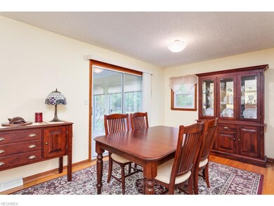 Open dining area with hardwood flooring and access