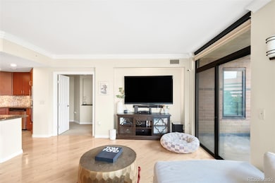 Living Room. Entry to primary and kitchen to the left, balcony on the right.