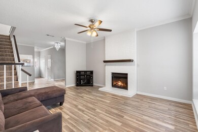 Living room with ornamental molding, a brick firep