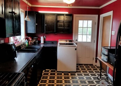 Kitchen features a gas stove, vinyl flooring and a