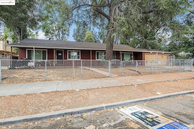 Ranch-style house featuring a fenced front yard, roof with shingles, and a gate