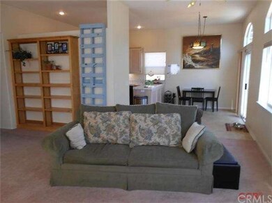 Living room with built in bookcases, looking into 