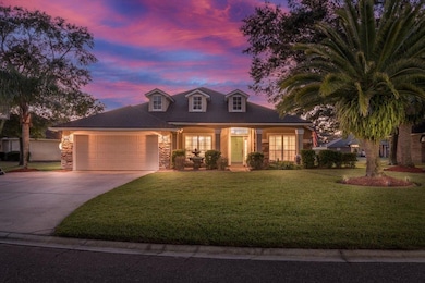 Cape cod-style house featuring a porch, concrete driveway, a lawn, and an attached garage