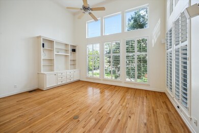 Towering windows with plantation shutters frame lu
