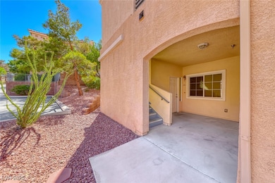 Property entrance featuring stucco siding and a pa