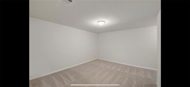 Empty room featuring carpet floors and baseboards