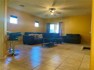 Living area with baseboards, light tile patterned