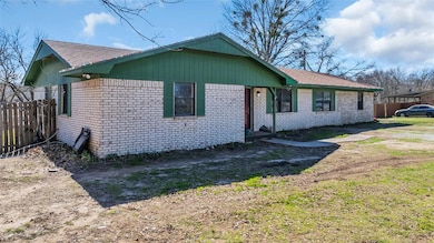 View of front of house featuring brick siding and a shingled roof