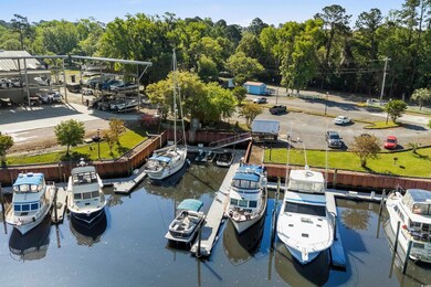 Dock area with a wooded view and a water view